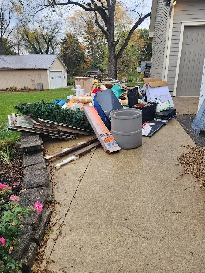 Dumpster being loaded with debris for Roofing Dumpster Rental in Spencer